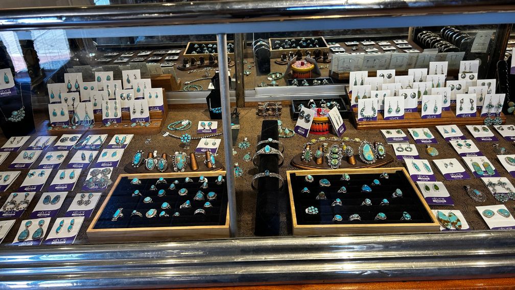 Turquoise and silver rings, earrings, and bracelets in a display case at Silver Assets jewelry store in historic Mesilla.